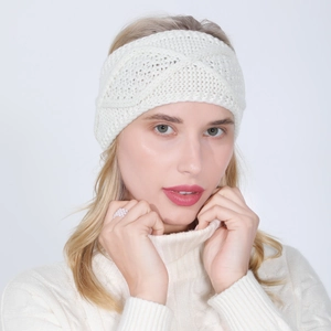 Detail of white knit headband featuring a chic cross-knot design and soft cable texture