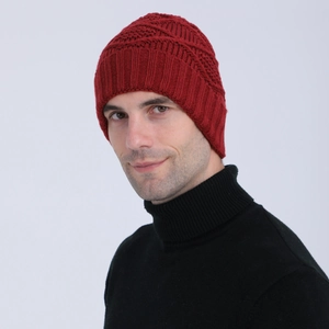 Front view of a man wearing a dark red knitted beanie with diamond weave and ribbed cuff