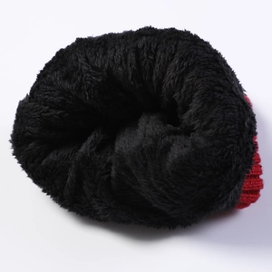 Close-up of thick thermal fleece lining and red knit fabric for winter headwear
