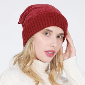 Close-up of deep red ribbed knit beanie showing textured warm fabric on a model