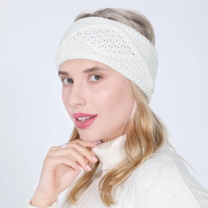 Detail of white chunky knit headband featuring intricate diamond cable patterns and twist