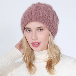 Close-up of pink knitted beret with fuzzy texture and glitter threads on a female model