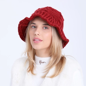 Close-up of thick knitted dark red bucket hat with textured weave for winter warmth