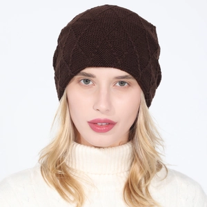 Close-up of a dark coffee knit beanie with diamond pattern on a blonde model