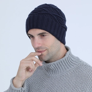 Detail of navy blue knit beanie showing vertical ribbed texture and geometric pattern