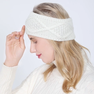 Detail of white twisted knit headband with soft texture for winter warmth