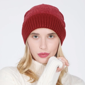 Close-up of deep red ribbed knit beanie with fold-over cuff and warm thermal lining