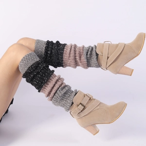 Detailed knit texture of tricolor grey black and pink leg warmers with suede boots