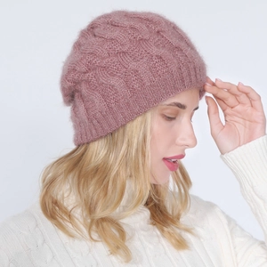 Close-up of pink cable knit beanie featuring soft fleece texture and ribbed cuff
