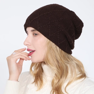 Detail view of dark coffee diamond-pattern knit beanie featuring soft thick texture