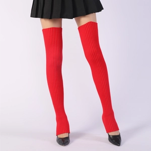 Detail of red ribbed knit over-knee leg warmers for ballet yoga showing thick texture
