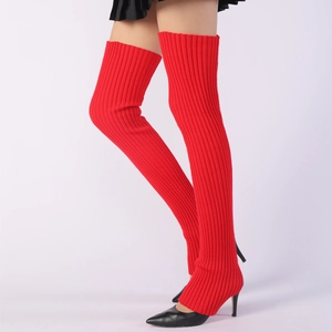 Detail of red ribbed knit thigh-high leg warmers styled with black high heel shoes