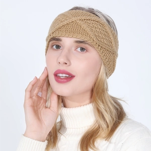 Detail of khaki cable-knit headband with cross-twist design for winter warmth