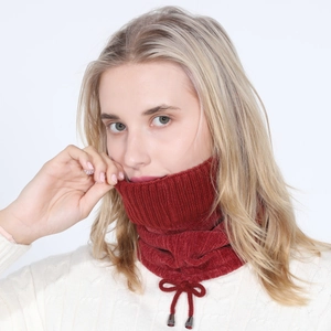 Detail of red fleece-lined knit scarf with adjustable drawstring and metal-tipped ends