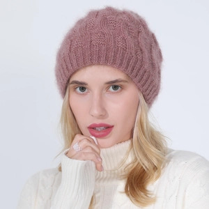 Detail of pink knitted beret with silver thread and soft texture for winter warmth
