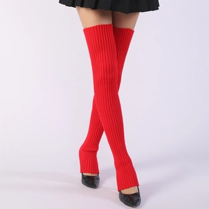 Close-up of red ribbed knit over-knee leg warmers styled with black pointed high heels