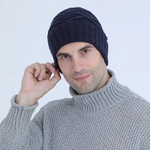 Detailed view of the navy blue knit beanie's thick texture and ribbed fold-over cuff