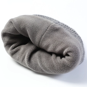 Detail of soft thick grey fleece lining inside the cable knit beanie for winter warmth