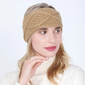 Close-up of khaki knit headband featuring thick cable knit texture and twist knot detail