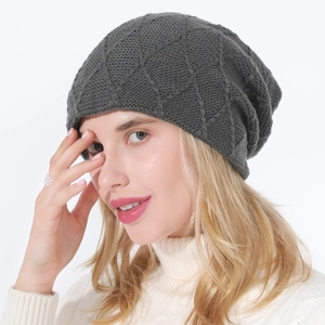 Detail of dark grey knit slouchy beanie featuring a textured diamond lattice pattern