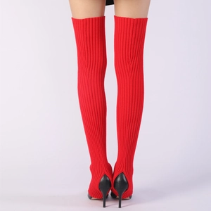 Detail of red knitted over-knee leg warmers with stirrup hole for high heels