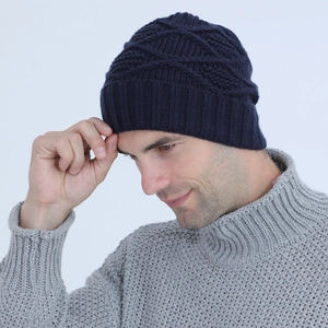 Close-up of navy blue winter knitted hat featuring a jacquard diamond pattern design
