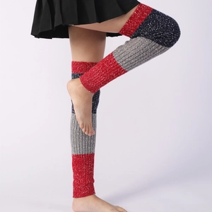 Detailed close-up of thick striped knit leg warmers with ribbed edges in winter style