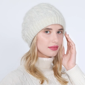 Detailed knit texture of white cable-knit beanie featuring soft warm mohair wool blend
