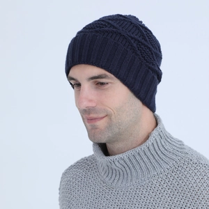 Close-up of navy blue knit beanie showing thick texture and ribbed cuff detail