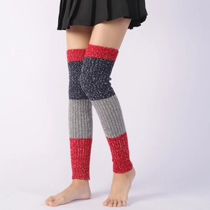 Close-up of tricolor knit leg warmers with snowflake patterns and thick ribbed texture