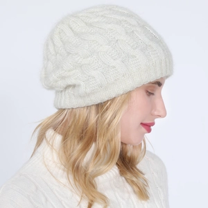 Detailed close-up of white cable knit beanie showing soft mohair texture and ribbing