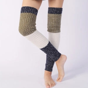 Thick knit knee-high leg warmers with tri-color snowflake pattern and ribbed texture