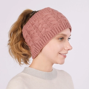 Detail of cable knit rose pink winter ear warmer headband for women's outdoor wear