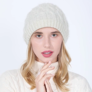 Detail of cream cable knit texture and soft fuzzy material on this warm winter beanie hat