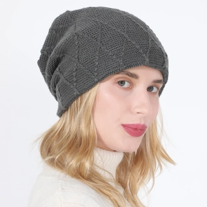 Detailed close-up of dark grey knitted beanie with diamond pattern texture for winter