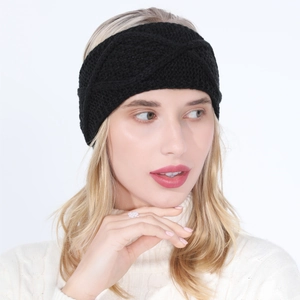 Detail of a black knit headband featuring a twist knot design and thick cable texture
