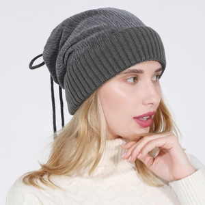 Detail of dark grey ribbed knit beanie showing the drawstring and fabric texture