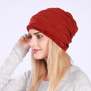 Close-up of deep red knitted beanie with thick fleece lining and diamond weave pattern
