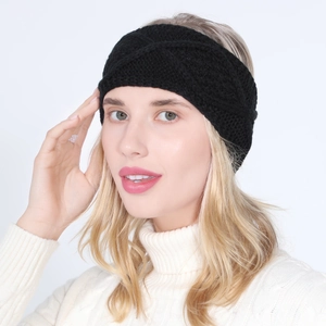 Detail of black cable knit headband with twist knot design worn by a blonde model