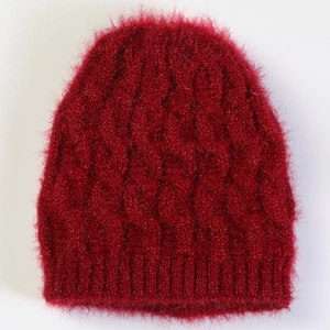 Close-up of cable knit texture and fluffy mohair yarn on wine red winter beret