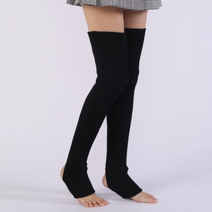 Detailed view of black knitted over-the-knee leg warmers with stirrup heel design