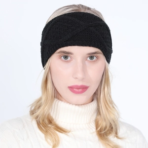 Detail view of black cable knit headband showing thick twisted pattern on female model