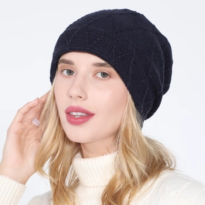 Detailed knit texture of a navy blue diamond-patterned winter beanie for cold protection