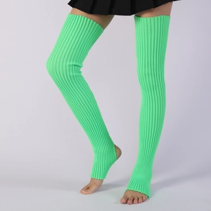 Close-up of bright green ribbed knit leg warmers with stirrup design for yoga