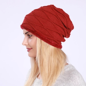 Detail of red knitted beanie featuring warm fleece lining and diamond weave pattern