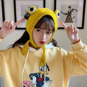 Close-up of yellow frog-style knit hat with cartoon character print hoodie