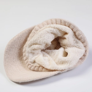 Close-up of winter knit peaked hat featuring thick warm fleece lining in beige