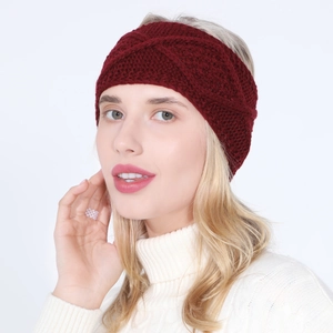 Close-up of wine red knitted headband showing intricate honeycomb stitch and twist detail