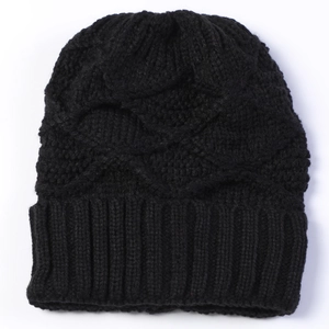 Close-up of black cable knit beanie texture with ribbed hem and thick yarn patterns