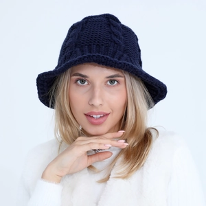Detail of navy blue cable knit bucket hat showing thick wool texture and wide brim